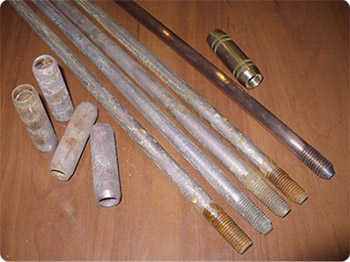 Black steel rods covered with corrosion